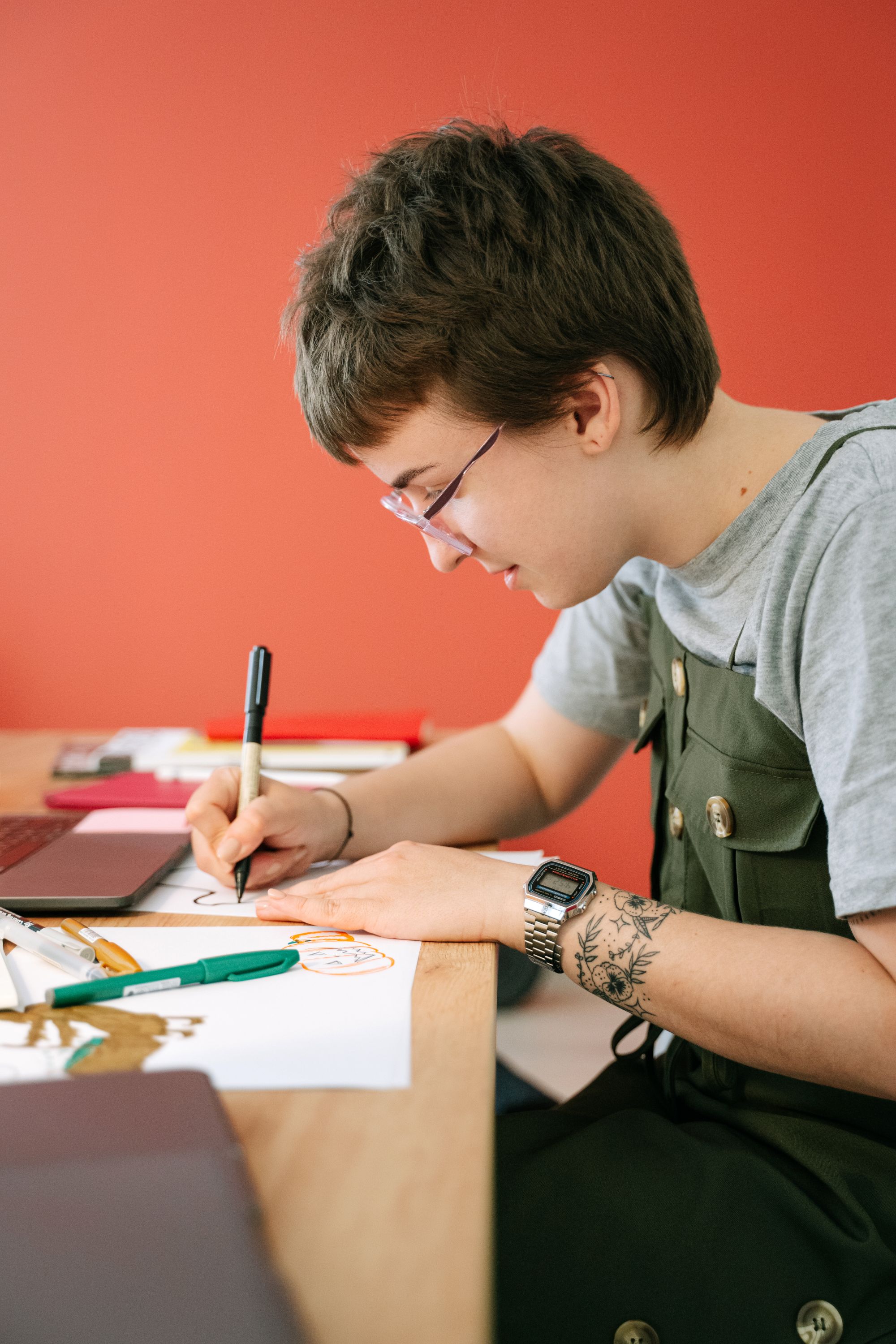 A designer drawing ideas by hand at a colourful desk