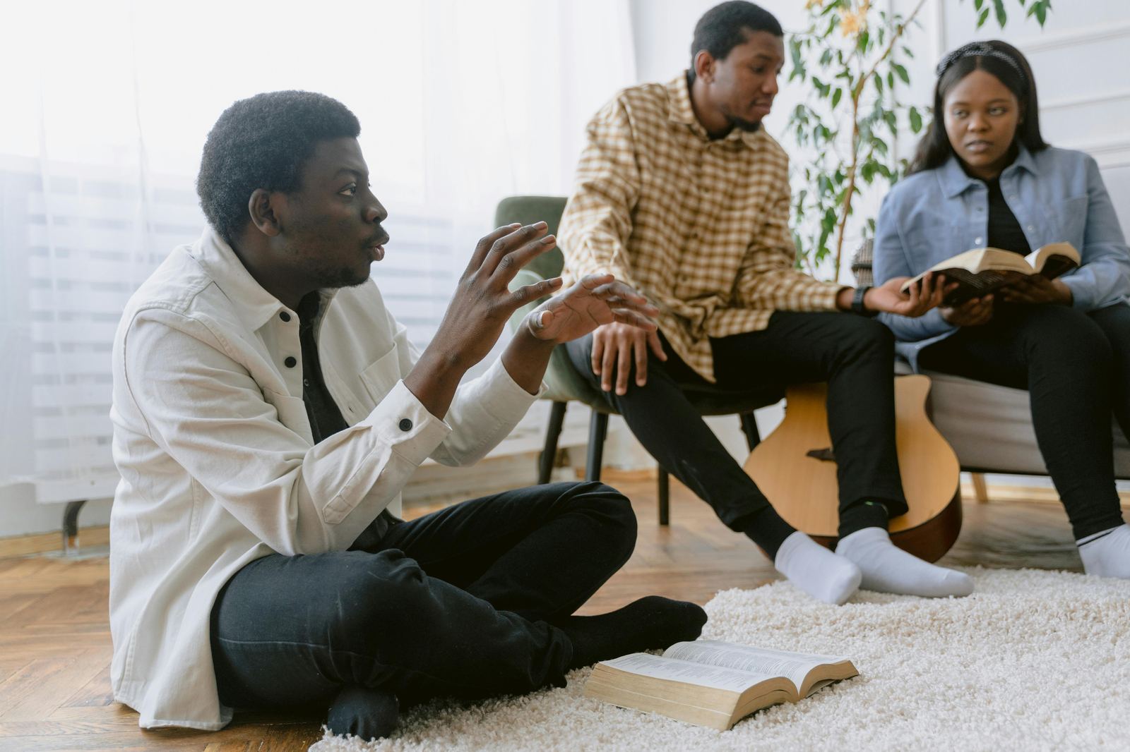 Three adults in a small group Bible discussion