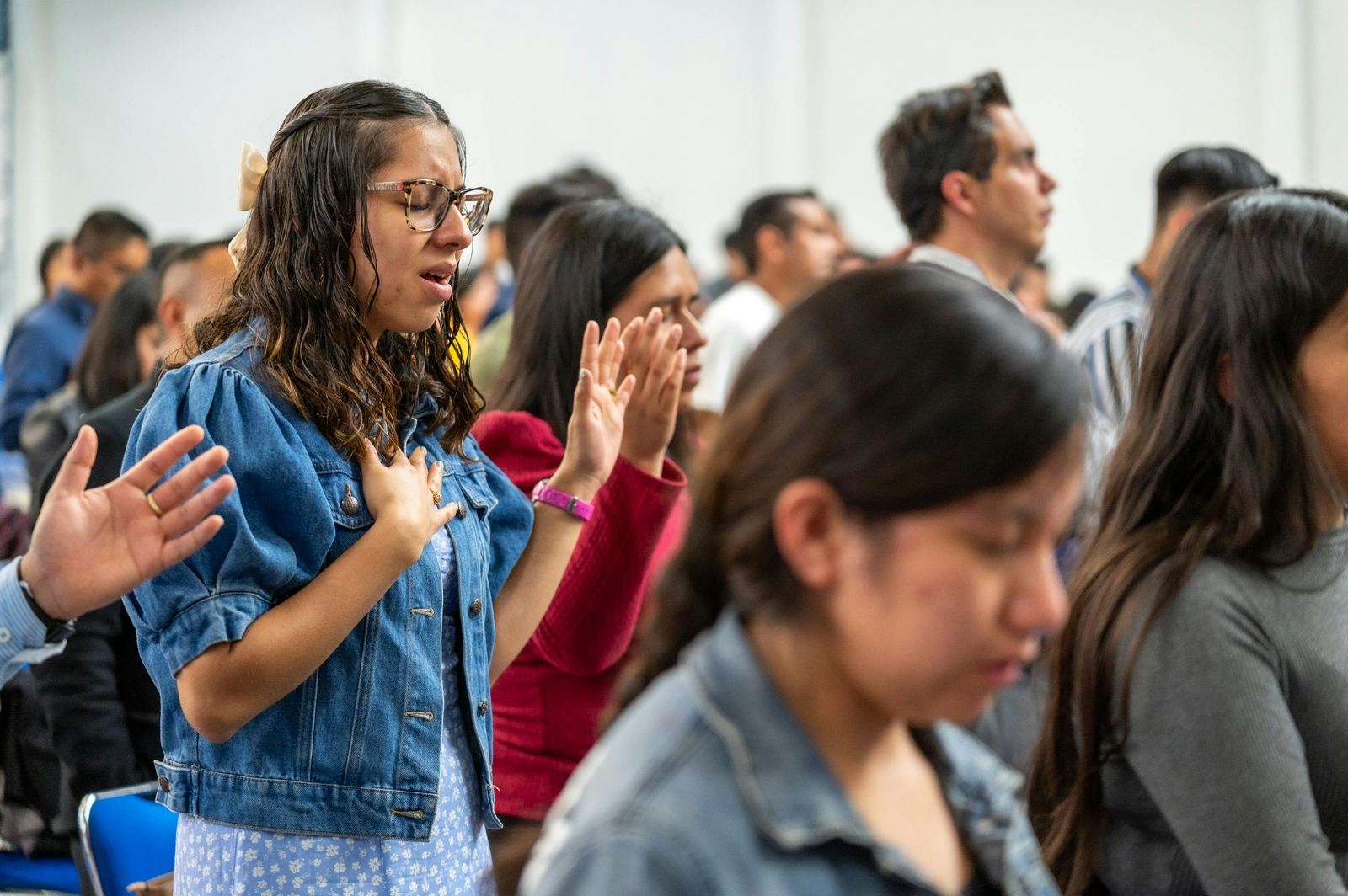 People gathered in worship and prayer during a church service