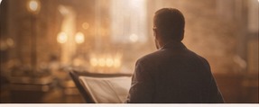 Pastor standing in a warmly lit sanctuary