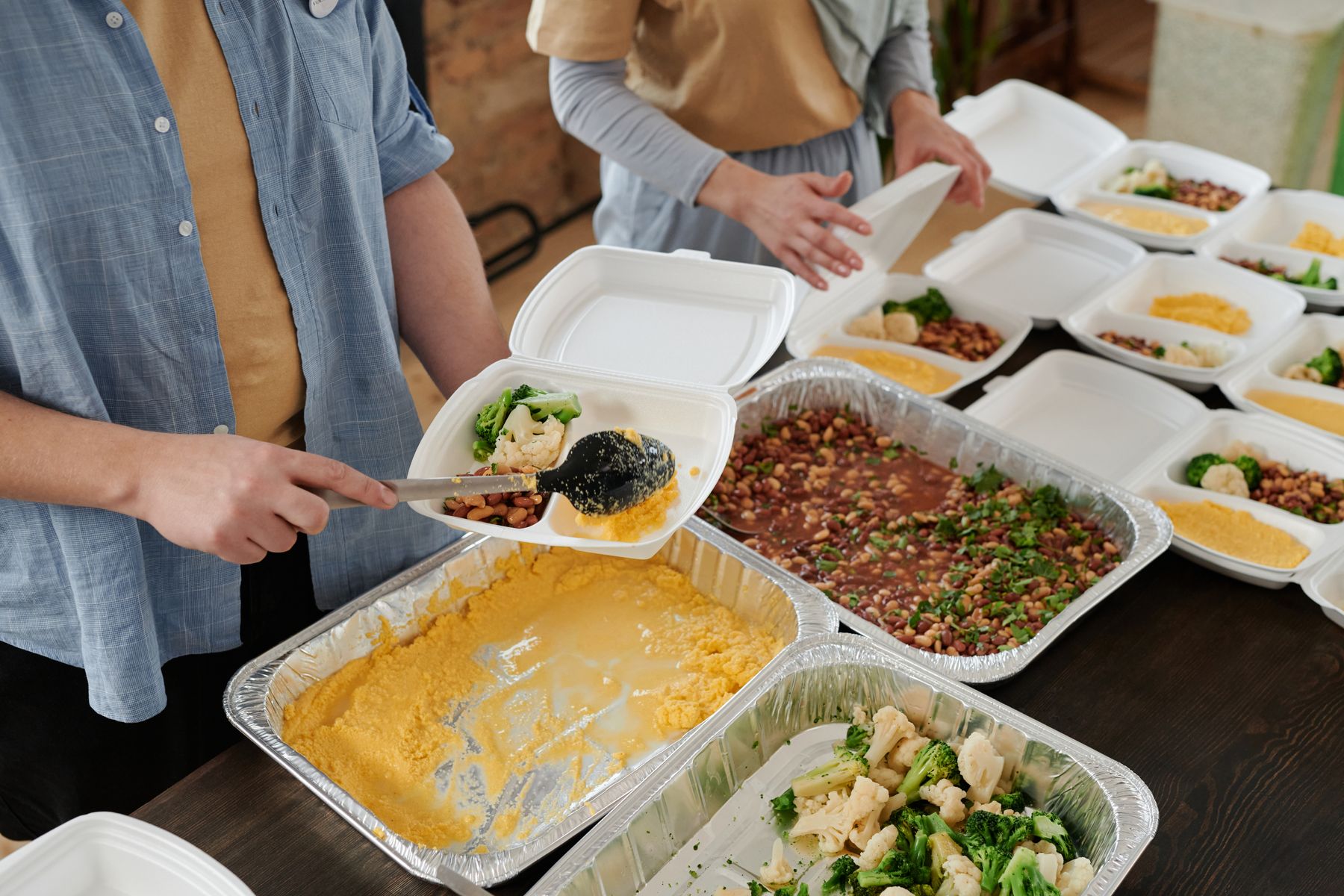Volunteers preparing food packs together