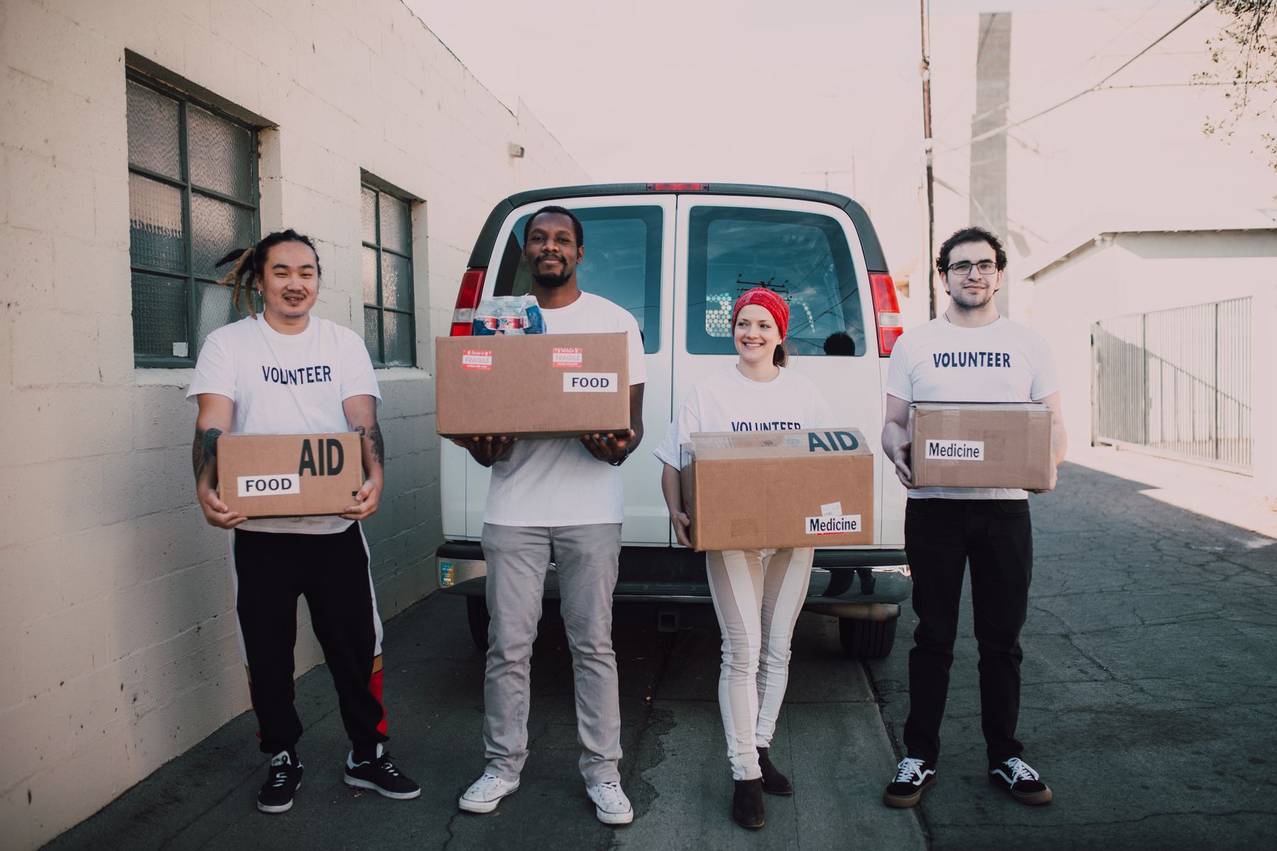 Volunteers standing together with boxes of supplies