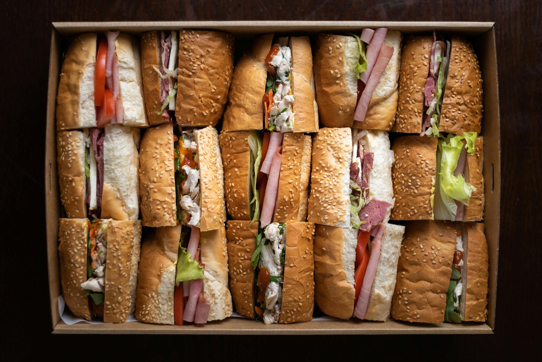 Box of assorted sandwiches for catering