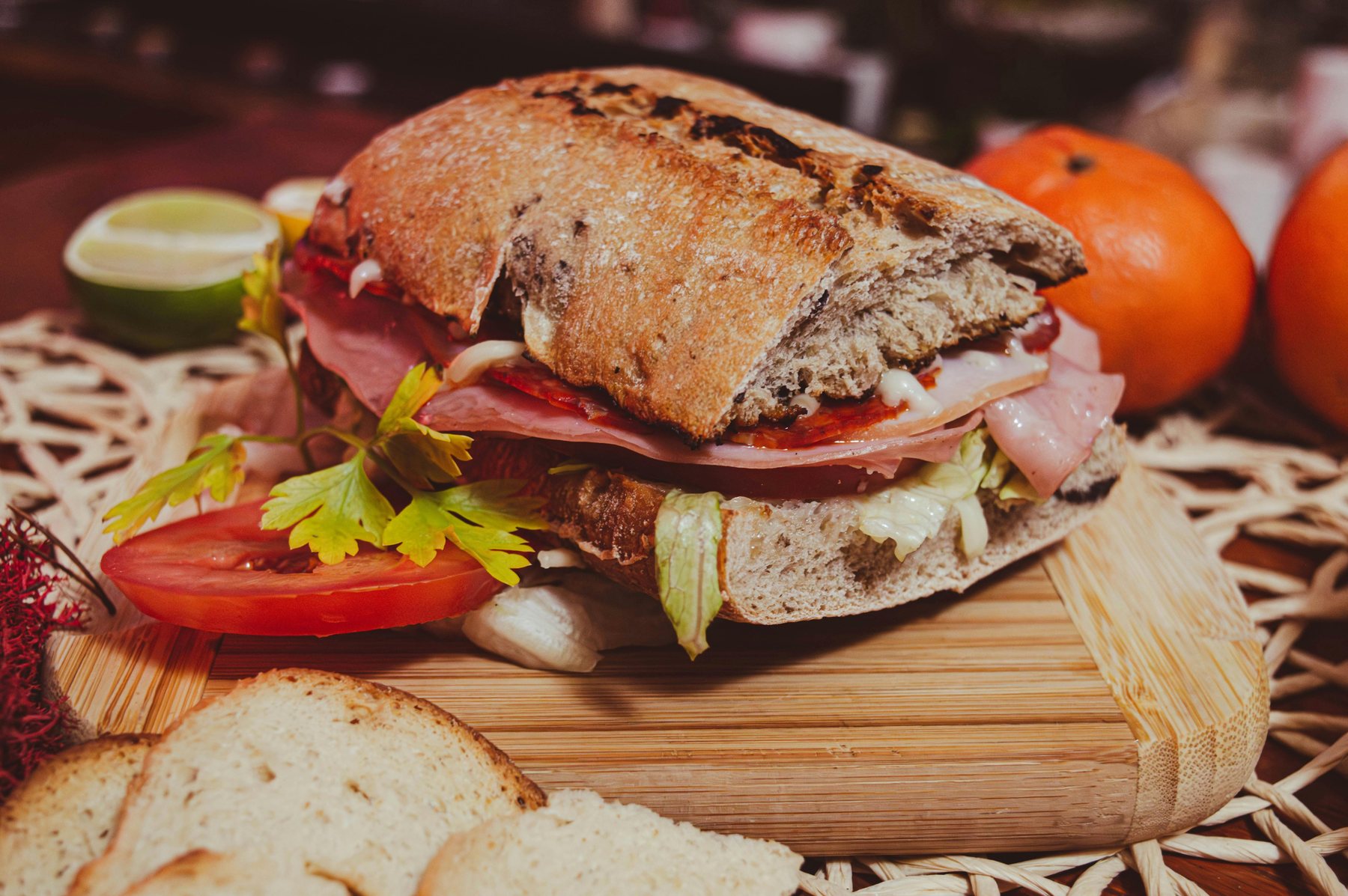 Pressed deli sandwich on a wooden board
